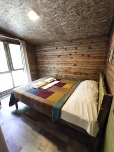 a bedroom with a bed in a wooden wall at Kure Dag Evi in Ulus