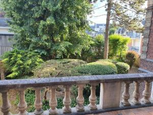 a stone railing in front of a garden at Lodge de la Gare Vue Cathédrale in Rouen