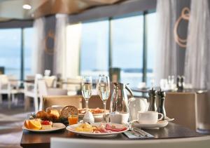 una mesa con dos platos de comida y copas de vino en Viking Line ferry Viking Grace - Mini-cruise from Turku, en Turku