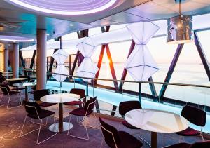 un restaurante en un crucero con mesas y sillas en Viking Line ferry Viking Grace - Mini-cruise from Turku en Turku