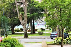 a car is parked in a park with trees at Marine Lux apartments in Pula