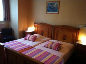 Postel nebo postele na pokoji v ubytování Hotel Georges