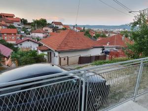 a car parked on the balcony of a house at Apartmani Sarti Banja Luka in Banja Luka