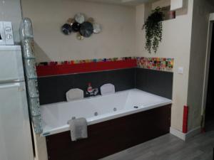 a kitchen with a tub in the corner of a room at Loft "Coqueto" Rojo in Ubrique +45 photos