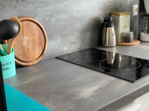 a kitchen counter top with a stove top oven at Maggies-Apartment-Hannover in Hannover