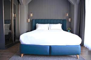 a large bed with a blue headboard in a bedroom at HOTEL BRONTE in Istanbul