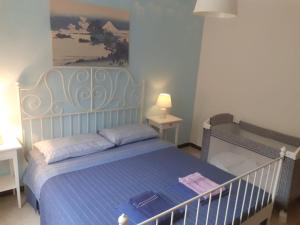 ラヴァーニャにあるLa casa nel verdeのベッドルーム1室(青いシーツと絵画付)