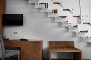 a living room with a desk and a staircase at 4- you Family in Metamorfosi