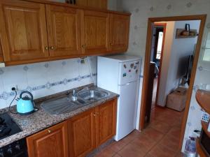 a kitchen with a sink and a white refrigerator at Quinta do Bosque in Vagos