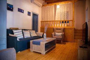 a living room with a couch and a table at The Water Mill Cottage in Lagoúdi Zía