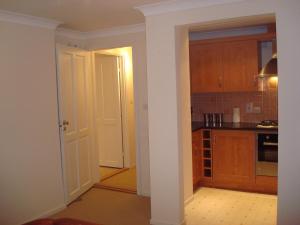 a kitchen with a door leading into a room at Riverside Apartment in Launceston