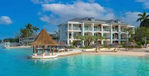 a large white building on the beach with the water at Sandals Royal Caribbean All Inclusive Resort & Private Island - Couples Only in Montego Bay