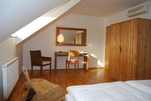 a bedroom with a bed and a desk in a attic at Obora 824 in Nová Bystřice