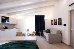 a living room with a couch and a table at NITI Palace in Castellammare del Golfo