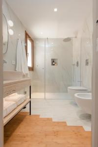 a white bathroom with a shower and a sink at NITI Palace in Castellammare del Golfo +96 photos