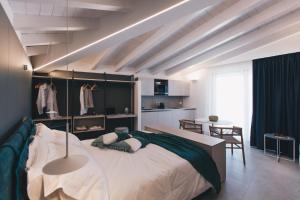 a bedroom with a large bed and a dining room at NITI Palace in Castellammare del Golfo