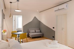 - une chambre avec un lit, une table et une chaise dans l'établissement OGNISSANTI GuestHouse & Suites, à Fermo