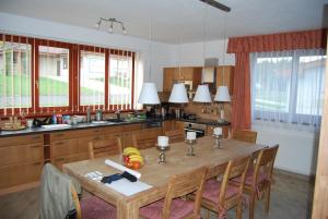 a kitchen with a wooden table with chairs and a tableasteryasteryasteryasteryastery at Obora 824 in Nová Bystřice
