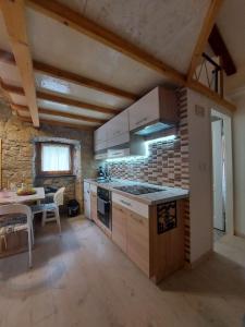 a kitchen with a stove and a table in it at DAMA in Brzac
