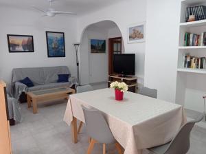 a living room with a table and a couch at Piso Grande Mercado Central Alicante in Alicante