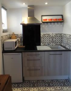 uma cozinha com um balcão e um micro-ondas em Laubertière em Marennes