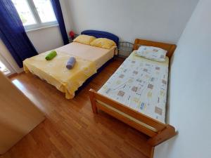 a bedroom with two beds and a window at Apartment Jure in Primošten