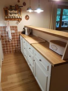 a kitchen with white cabinets and a counter top at Ferienhaus Erika in Mallnitz