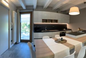 a kitchen and dining room with a table and chairs at La Volta - Molino Maufet Mühle - Patio on the garden in Colico