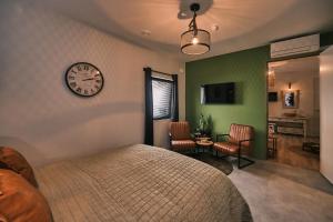 a bedroom with a bed and a clock on the wall at Stadshotel Weert in Weert