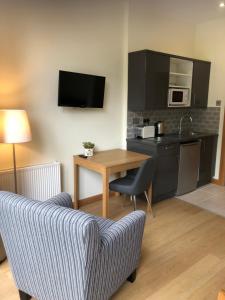 a living room with a table and a couch at Courtyard Mews in Armagh