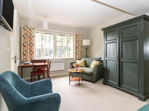 a living room with a couch and a table at The Barn at Sandhole Cottage in Tonbridge