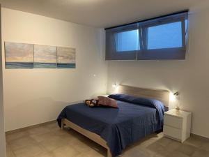 1 dormitorio con cama y ventana en Apt. Pieve San Michele by Agenzia Solturelba en Capoliveri