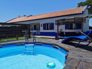a swimming pool in front of a house at HERDADE PALMA t1 in Moita