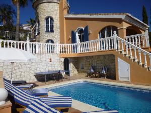 a villa with a swimming pool and a house at Casa Alexandro in La Cala de Mijas