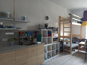 a kitchen with a sink and a bunk bed at Evergreen Hostel Krakow in Kraków