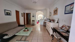 a living room with a couch and a table at Roberto Guest House in Benalmádena