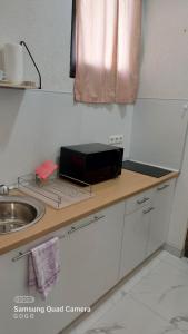 a kitchen counter with a sink and a box on it at Studio Apartman Malkoc in Bihać
