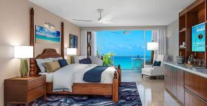 a bedroom with a bed with a view of the ocean at Sandals South Coast All Inclusive - Couples Only in Savanna-la-Mar