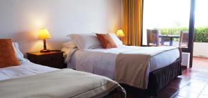 Ένα ή περισσότερα κρεβάτια σε δωμάτιο στο Hotel Mesón de los Virreyes