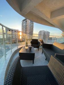 a balcony with couches and a table on a building at Seafront Mamaia - Casa Del Mar Residence in Mamaia