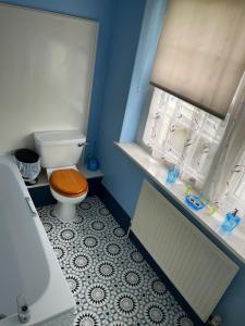 a small bathroom with a toilet and a window at the Dartmoor bnb in Yelverton