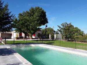 a swimming pool in front of a fence at La Bonbonne en Provence in Travaillan