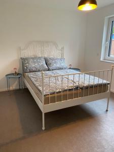 a bedroom with a bed with a white bed frame at Deluxe Ferienwohnung für 4 bis 6 Personen Ladestation E-Auto & E-Bike in Lancken-Granitz