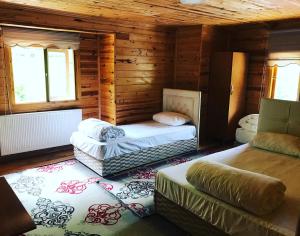 a room with two beds in a log cabin at Irmak Apart in Çamlıhemşin