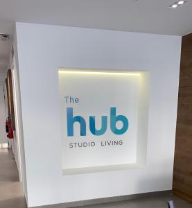 a sign for the hub studio living in a white wall at CP Top floor luxury studio in Gibraltar