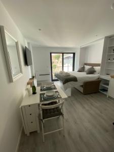 a bedroom with a bed and a desk and a bed and a desk at CP Top floor luxury studio in Gibraltar