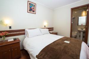 Postel nebo postele na pokoji v ubytování Antawasi Hotel