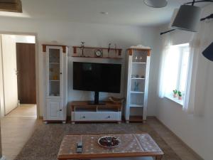 a living room with a flat screen tv on a wall at Ferienhaus Kranichzauber in Klausdorf Mecklenburg Vorpommern