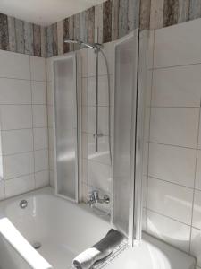 a bathroom with a shower and a tub and a sink at Ferienhaus Kranichzauber in Klausdorf Mecklenburg Vorpommern +12 photos