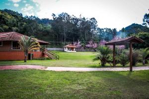 a yard with a house and a pavilion at Pousada das Flores in Gonçalves